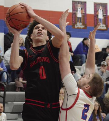 RICHMOND SENIOR Gabe Johnson attempts a shot in the post while contested by Colten Sawyer of Lexington. SHAWN RONEY | Staff