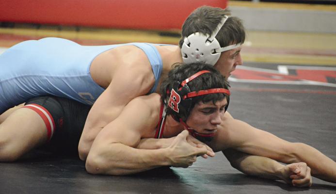 RICHMOND JUNIOR Madix Hutchings uses his right hand to try to break a hold by Ben Schroeder of Father Tolton Regional Catholic. For additional wrestling coverage, see page 16. SHAWN RONEY | Staff