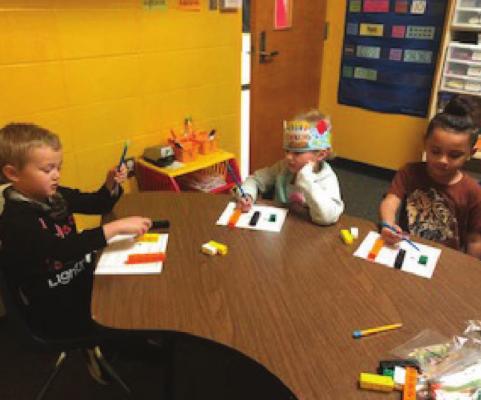 CORISSA HAMILTON’S children use connecting cubes to show different pairs of numbers that make connecting cubes. The students are Jayce Rodriguez, Barbara Floyd and Arthur Bivines.