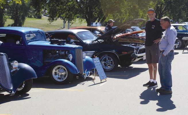 RON DELAY admires the 1933 Ford owned by Steve Dillon (left). SHARON DONAT | Staff