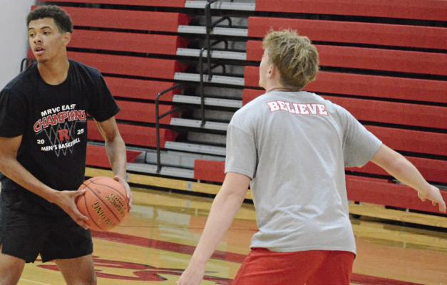 BRICE DOME (left) looks to pass during a Richmond off-season camp session. SHAWN RONEY | Staff