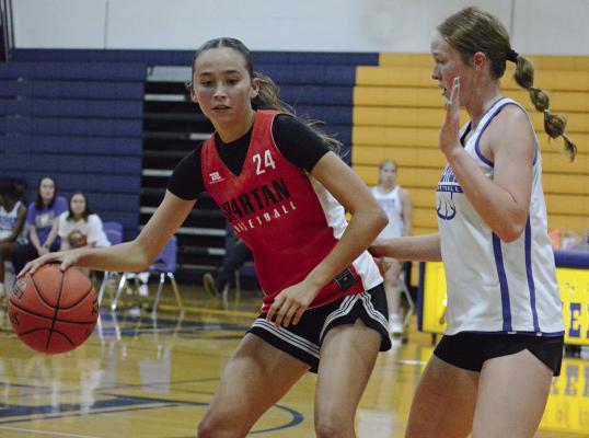 BRYLEE CASTILLEJA (left) and her Richmond teammates get a look at Missouri River Valley Conference-East Division rival Lafayette County of Higginsville during summer-league play. SHAWN RONEY | Staff
