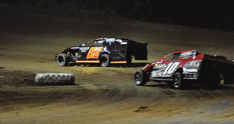 DRIVING THE NO. 82 car, Richmond’s David Wood barrels through a corner during a night race July 4 at Central Missouri Speedway near Warrensburg. SHAWN RONEY | Staff