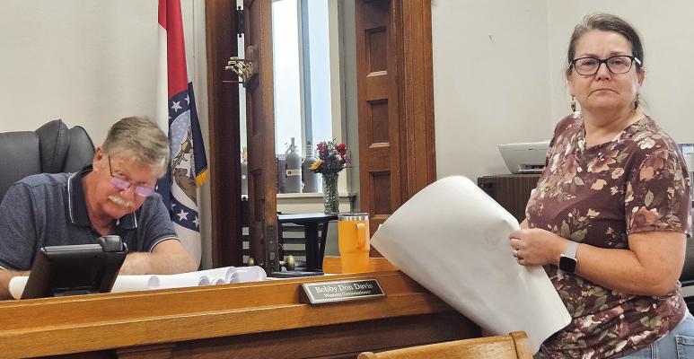 PLANNING AND ZONING Administrator Stacy Wolfe reviews plats and ordinances with county commissioners before the documents are signed. MIRANDA JAMISON | Staff