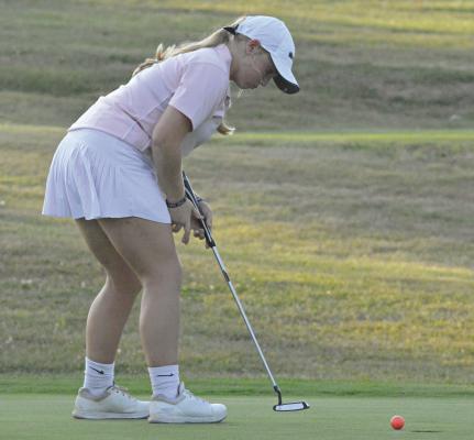 KAROLINE DOOLEY watches one of her putts roll into the hole during Richmond’s recent dual with Center at Shirkey Golf Course. SHAWN RONEY | Staff