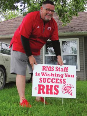KENT WOLLARD plants a sign.