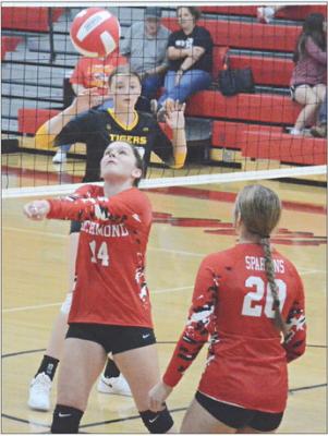 WITH FELLOW SPARTAN Avory Oliphant watching, Richmond sophomore Sydnee Burnett bumps the ball Sept. 14 during a best-of-five varsity volleyball match with visiting Wellington-Napoleon. SHAWN RONEY | Staff
