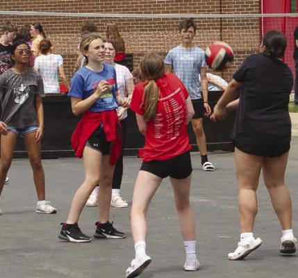 ERIANNA ELEGINO (from left), Kayla Hamm and Jaxson Ahart join in on the volleyball fun.