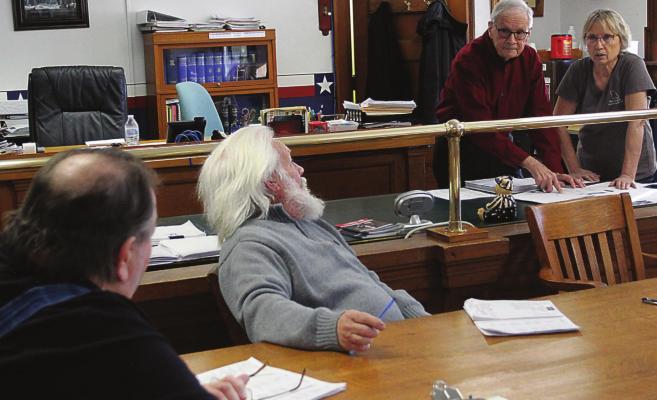 THE THREE COMMISSIONERS and the county clerk discuss budgeting and proposed 3% raises for all county employees, including officeholders. From left are Commissioners Gary Wilhite, Dave Powell and Bob King, and County Clerk Glenda Powell. J.C. VENTIMIGLIA | Staff