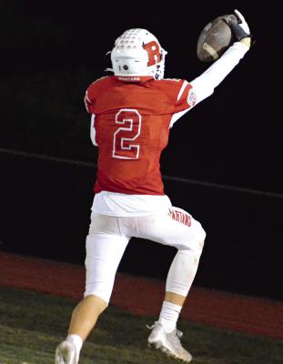 RICHMOND JUNIOR Bryer Farnan holds the football high as he leaps into the end zone for a thirdquarter touchdown Oct. 20 in The Bell Game against visiting Lexington. SHAWN RONEY | Staff