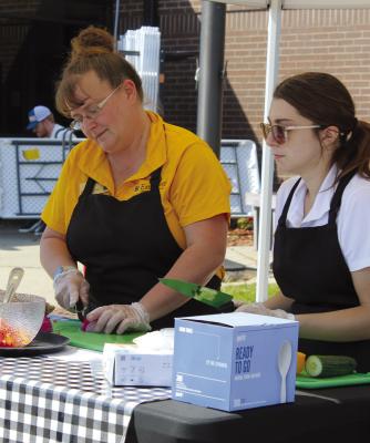 REGIONAL FOOD SYSTEM managers Deb O’Neal (left) and Ellen Bloomer-Thornton demonstrate an easy summer recipe using items available from local farmer’s markets.