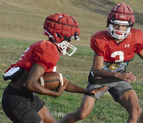 RICHMOND SENIOR Chris Webb (left) looks to get past teammate Brice Dome Monday on the high school practice field as the Spartans prepare to face archrival Lexington Friday in The Bell Game at Lexington. SHAWN RONEY | Staff