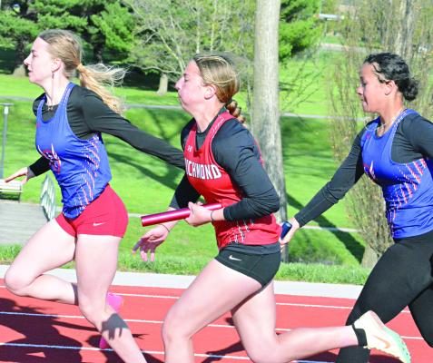 SHAWN RONEY | Staff RICHMOND JUNIOR SYDNEY APPLEBERRY bolts down the front straightaway and fights off a challenge from Lexington during the second leg of the girls 400-meter relay at the Bruce Finlayson Invitational April 21 at Carrollton.