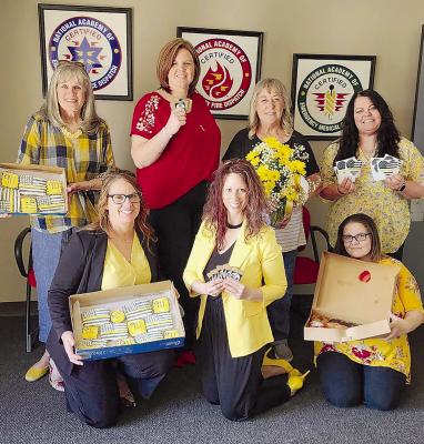 JANET LABARR (FROM LEFT), JENNIFER GRIMES, Heather Miller, Camille Johnston, Kim Davis, Tara Medlin and Melissa White celebrate National 911 Public Safety Telecommunications Week together. SOPHIA BALES | Staff