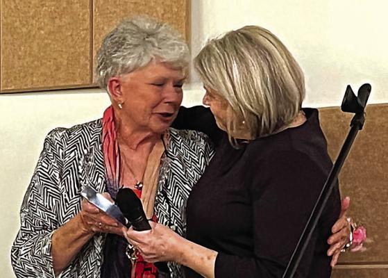 PEGGY HACKETT, left, and Stephanie Landwehr hug while Hackett accepts the Lifetime Award Oct. 20 from the chamber for her business, JP’s Total Image. SOPHIA BALES | Staff
