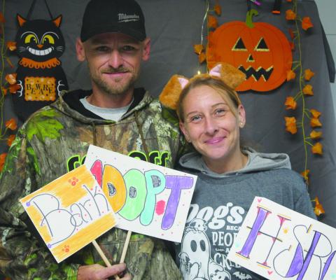 BRAD ADAMS (LEFT) AND Kelly Legate visit the Humane Society of Ray County’s new location at 104 North McCart Street for an open house where attendees toured the new shelter and met animals available for adoption. SHARON DONAT | Staff