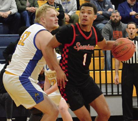 RICHMOND JUNIOR Brice Dome (right) attempts to drive past Lafayette County post player Lucas Burns during the Husker Classic. Additional tournament photos are on page 15. SHAWN RONEY | Staff