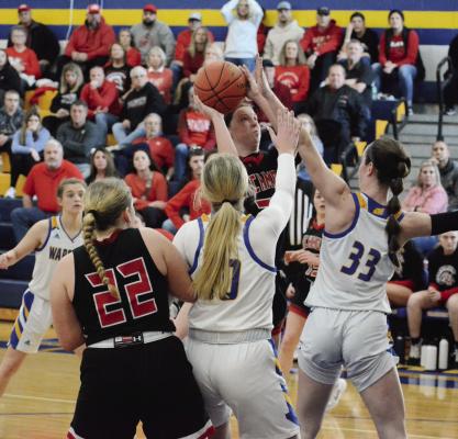 RICHMOND SENIOR Trinidy Fisk attempts a short jump shot over the outstretched left hand of St.Pius X senior Molly Cernich during Richmond’s 51-31 season-ending loss March 4 in Kansas City on the St. Pius campus. SHAWN RONEY | Staff