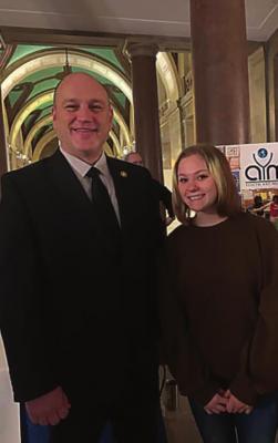 ORRICK School District eighth-grader Destiny Rohde creates a piece of art that state Sen. Denny Hoskins chooses to represent the 21st Senatorial District in the 2022 Senate Student Arts Exhibition. With Hoskins, left, she appears at the Capitol in Jefferson City. At right, she shows her painting hanging in the Capitol building.
