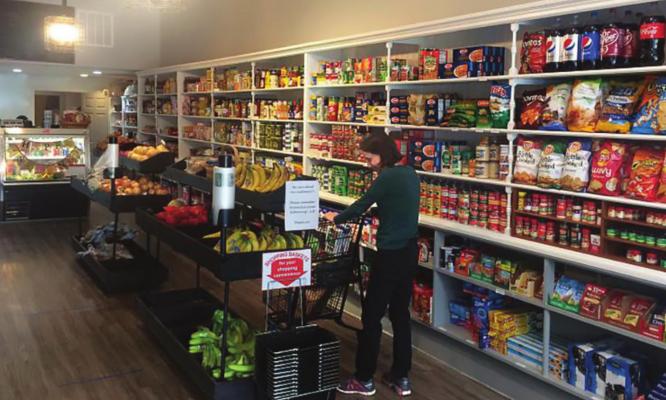 RUN BY John Paul Coonrod, Great Scott Community Market fits inside an old shoe store. DANA CRONIN | Harvest Public Media