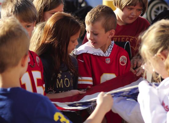 SOPHIA BALES | Staff FOURTH-GRADERS Fynleigh Orr and Jahred Case help others fold the American Flag Sept. 9 at Sunrise Elementary in Richmond as the students learn about flag etiquette from VFW members.