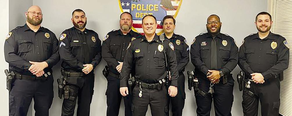 SEVERAL RICHMOND POLICE OFFICERS received awards and promotions during a recent Richmond City Council meeting. Detective Aaron Adkins, Cpl. Tomas Rodriguez, Lt. Brandon Ray, Interim Chief Scott Bagley, Sgt. Luke Covey, School Resource Officer Romulus Davis and Cpl. Cody Davis are seen here getting together and celebrating their promotions. SOPHIA BALES | Staff