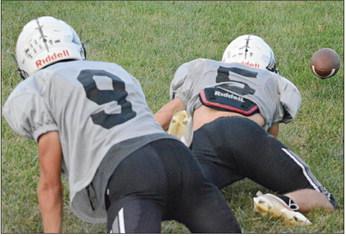 SHAWN RONEY | Staff BRODY FIFER (left) and Drew Hawkins scramble for a loose football as the Aggies practice their tackling Monday at Hardin-Central.