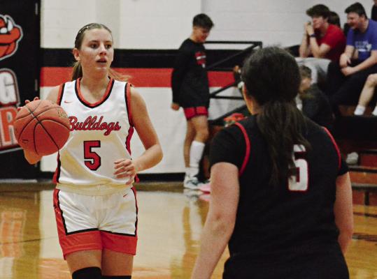 ESTER KINCAID (left) is guarded by Kaitlyn Kellam during Hardin-Central’s season opener with Northland Christian Nov. 17 at Hardin-Central. SHAWN RONEY | Staff