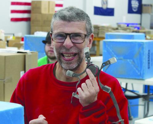 DENNIS MCGOLDRICK, an Ideal Workshop employee, assembles a mask to show open house attendees. See more photos on page 9. SHARON DONAT | Staff