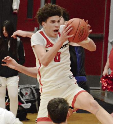 GABE JOHNSON, one of four seniors playing varsity basketball at Richmond, has a firm grip on the ball during the Spartans’ Senior Night win over Holden. SHAWN RONEY | Staff