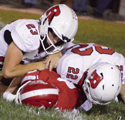 RICHMOND SOPHOMORES Bryson Pruitt (left) and Mack Misenhelter finish a tackle against Carrollton to help the Spartans post their first shutout this season in varsity 11-man football. SHAWN RONEY | Staff