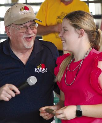 KMMO REPRESENTATIVE Larry Smith (left) presents a belt buckle to Allison Coats of Richmond, recognizing her hard work within the FFA organizations.
