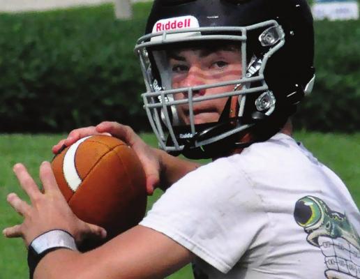 BRAYDEN SCHICK looks to pass during an NHC preseason practice. But the Aggies use their running game to romp to a season-opening win. SHAWN RONEY | Staff
