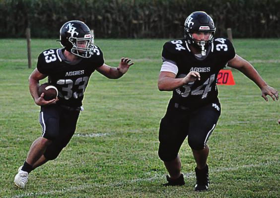 KEYTON LAIRE, No. 34, leads the way for running back Brayden Schick during Norborne Hardin-Central’s Sept. 3 varsity 8-man football clash with Knox County at Norborne. SHAWN RONEY | Staff