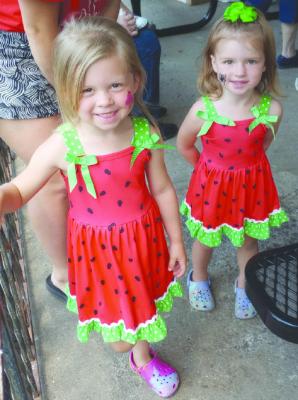 OLIVIA AND CHLOE DEHN, with faces painted, step up to get hot dogs for lunch at Victory in the Park.