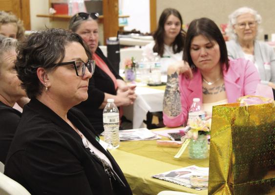 OUTSTANDING WOMAN in Business and Leadership nominee Cindy Thornberry (left) listens to the speaker along with other attendees of the luncheon and awards ceremony. MIRANDA JAMISON | Staff