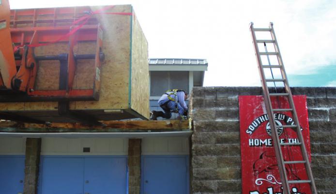 UP ON THE ROOF at the Richmond pool, CentiMark Corp. employee Christopher Jordan engages in repairs. J.C. VENTIMIGLIA | Staff