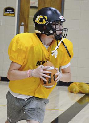 ORRICK QUARTERBACK Jonathon Harris eyes his receiver as he hones his passing skills during team camp Monday in the Orrick High School gym. SHAWN RONEY | Staff