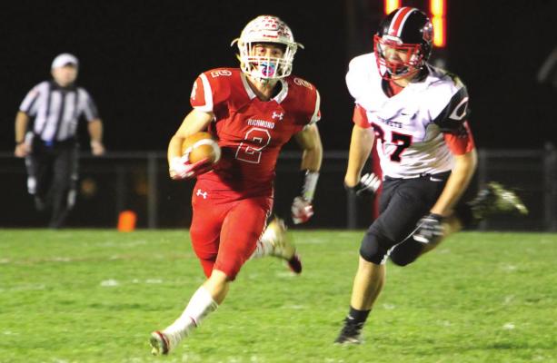 JUNIOR wide receiver Layne Cavanah gains first-down yardage on a night when he scores three touchdowns and sets up Richmond for a fourth in the team’s 62-35 playoff win against Chillicothe.