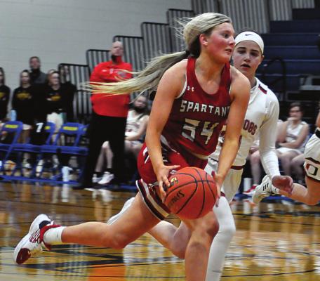 RICHMOND SENIOR Emmalea Kilpatrick pushes the ball down the court during the fourth quarter of the Spartans’ three-point loss Tuesday to Odessa at the Husker Classic in Higginsville. SHAWN RONEY | Staff