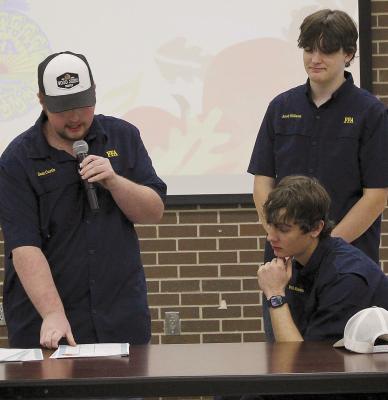 SAM CURTIS (from left), Will Robinson and Jacob Williams announce the winners of the silent auction to the over 90 attendees of the FFA Fall Harvest Dinner. SHARON DONAT | Staff