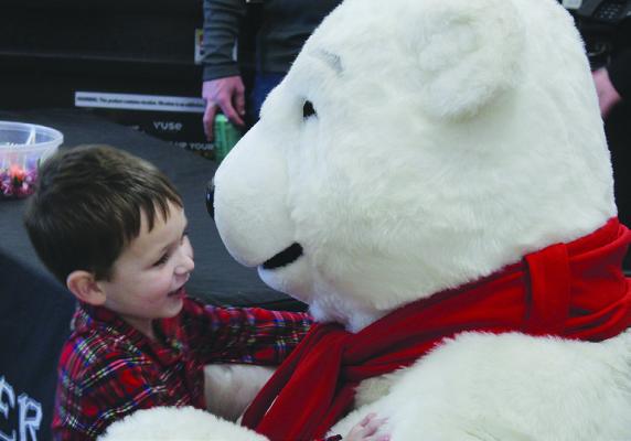 TOMMY GOOD goes in for a hug with the polar Bear.