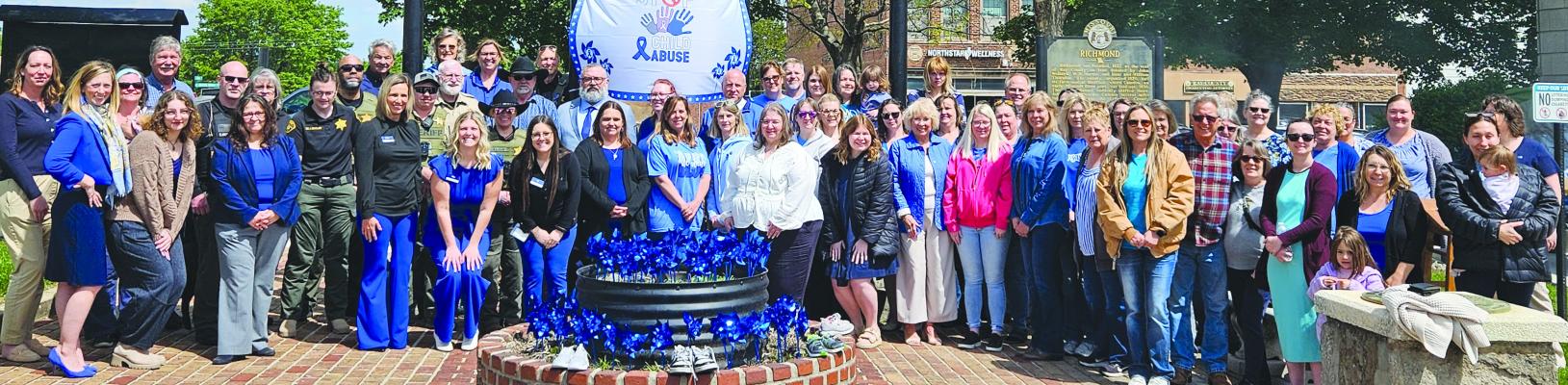 COMMUNITY MEMBERS, local officials and child advocacy partners raise awareness for Child Abuse Awareness Month during a courthouse event focused on protecting children in Ray County. MIRANDA JAMISON | Staff