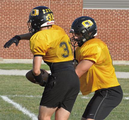 JEFF ROHDE (No. 31) fakes a handoff from Orrick senior quarterback Jaxon Miller Monday afternoon at Simmons Field as the Bearcats prep for Friday’s home meeting with Missouri Highway 10 rival Norborne Hardin-Central. SHAWN RONEY | Staff
