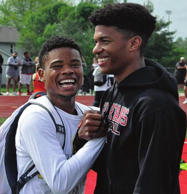 ADRIAN CHURCH, left, and Jordan Alexander enjoy the news of hearing they, along with teammates Layne Cavanah and Keyshaun Elliott, have broken Richmond’s school record in the boys 400-meter relay. SHAWN RONEY | Staff