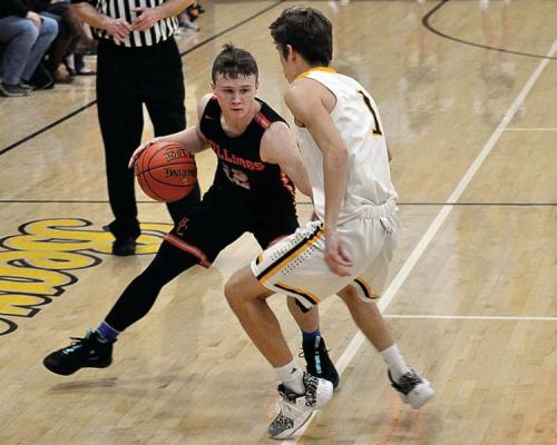 HARDIN-CENTRAL freshman Mason McCaulley looks to dribble around Orrick senior Gabe McAfee Friday night in varsity boys basketball action. Sparked by a 10-2 opening run, Orrick leads 13-6 after one quarter. Hardin-Central, however, makes it a two-point ballgame by outscoring Orrick 15-10 the second quarter. The Bearcats respond by outscoring the Bulldogs 32-22 the second half to win their homecoming 55-43.