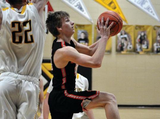HARDIN-CENTRAL sophomore Mason Freece goes up and under Orrick junior Dylan Comstock to attempt a layup Friday night in non-conference varsity boys basketball action. It is a two-point ballgame at halftime, but Orrick pulls away during the second half for a 55-43 non-conference and courtwarming win. The Bearcats (11-7), who snap a two-game losing streak with their victory, return to I-70 Conference play Tuesday at Crest Ridge. The Bulldogs (3-11) are scheduled Tuesday to host Chilhowee. 