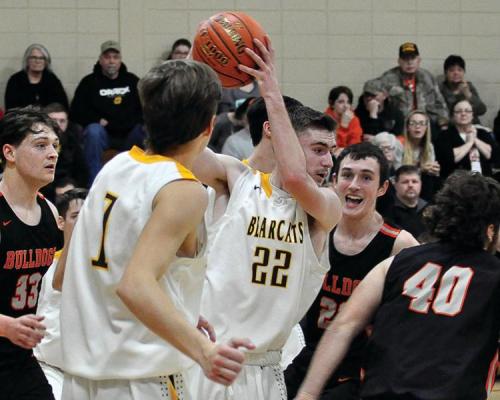 DYLAN COMSTOCK has control of the basketball for the Bearcats Friday night during their 55-43 courtwarming win over Hardin-Central.