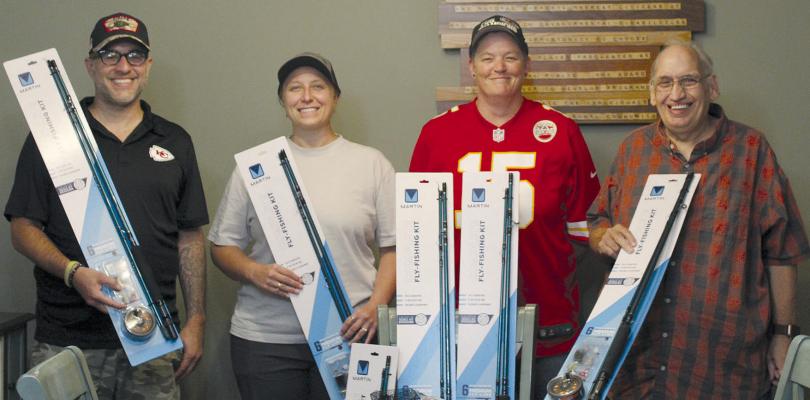 JESSE GRECO (from left) and Courtney Bock from South O Bones LLC donate fly-fishing equipment to Daitlin Cowley and Robert Cox of Special Needs services. SHARON DONAT | Staff
