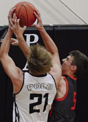POLO SENIOR Maverick Gentry (left) and Hardin-Central sophomore Brody Fifer fight for a first-half rebound.